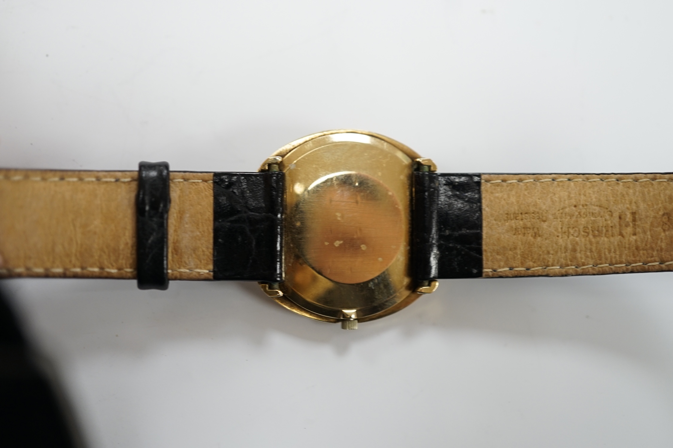 A gentleman's 9ct gold black dial manual wind wrist watch, with Omega box.